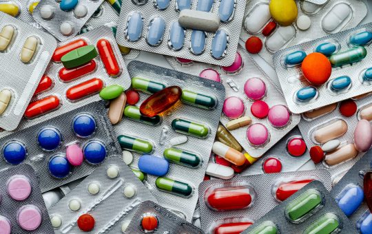 Background of a large group of assorted capsules, pills and blisters